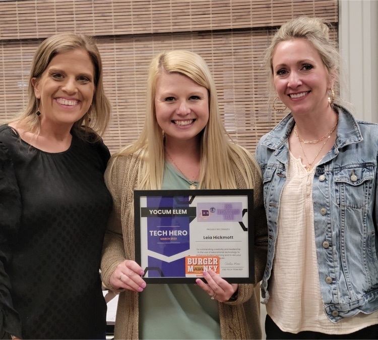 three adults, one holding a certificate 