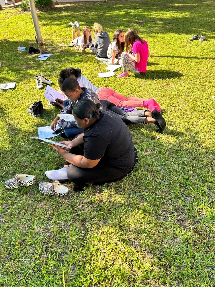 kids on the ground reading 
